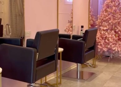 Stylish beauty salon chairs and pink decor at bees. in Paisley, Scotland, GB.