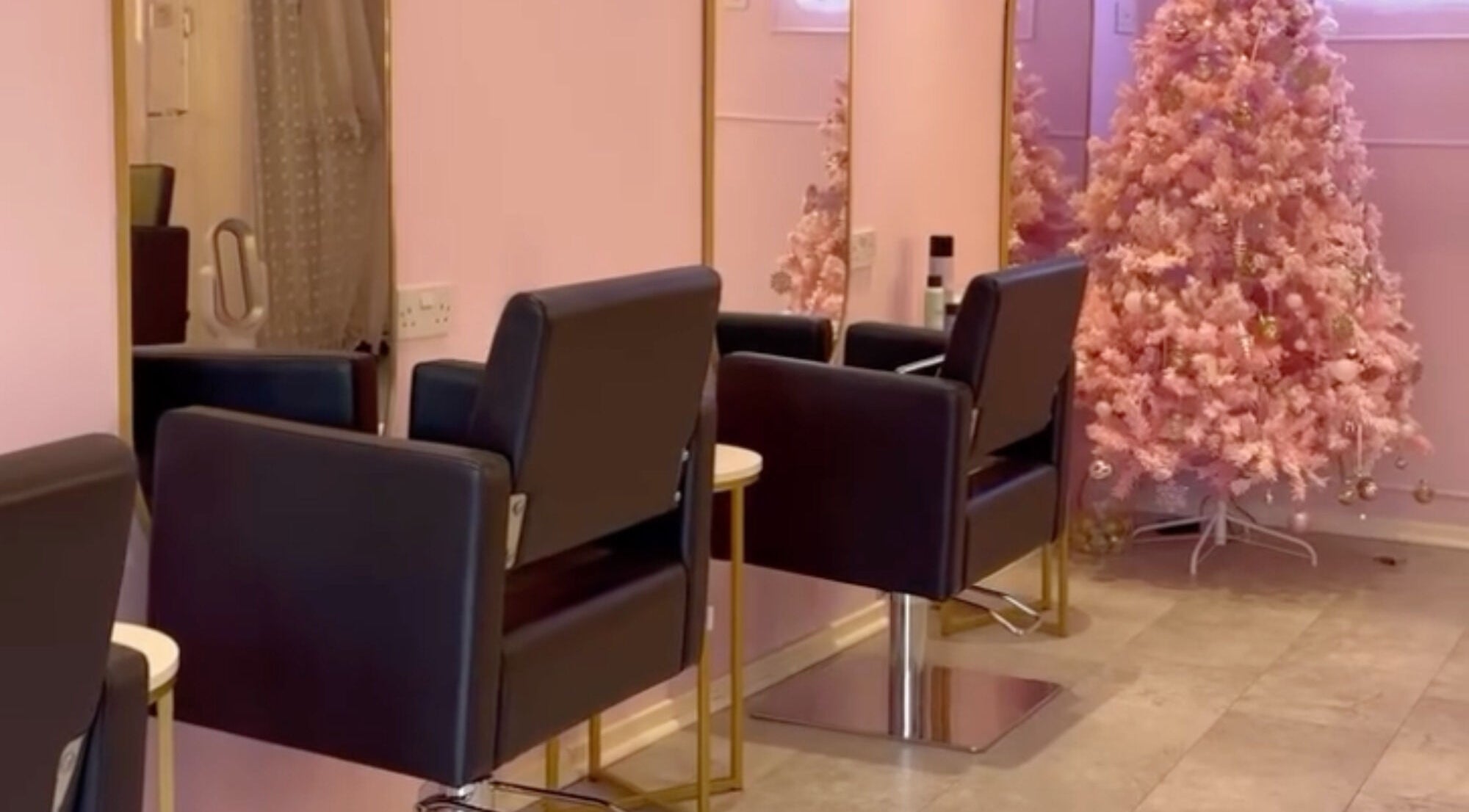 Stylish beauty salon chairs and pink decor at bees. in Paisley, Scotland, GB.