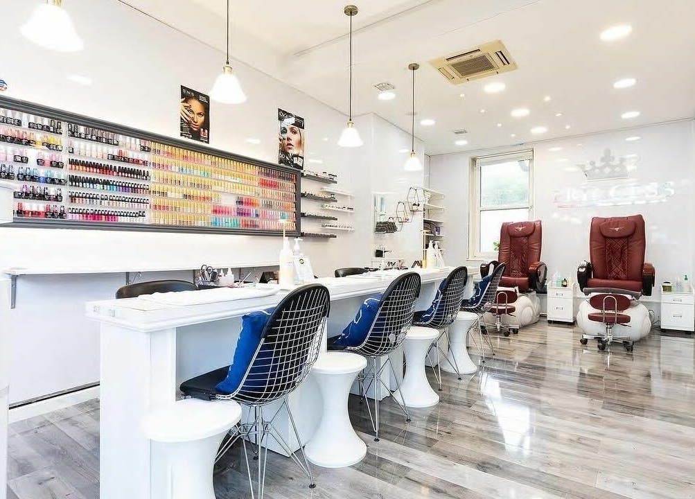 Elegant interior of Princess Nails and Beauty in London, England, GB with modern nail stations and product displays.