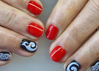 Vibrant red and black nails with intricate designs at Nails by Kelly, Waipu, Northland, NZ.