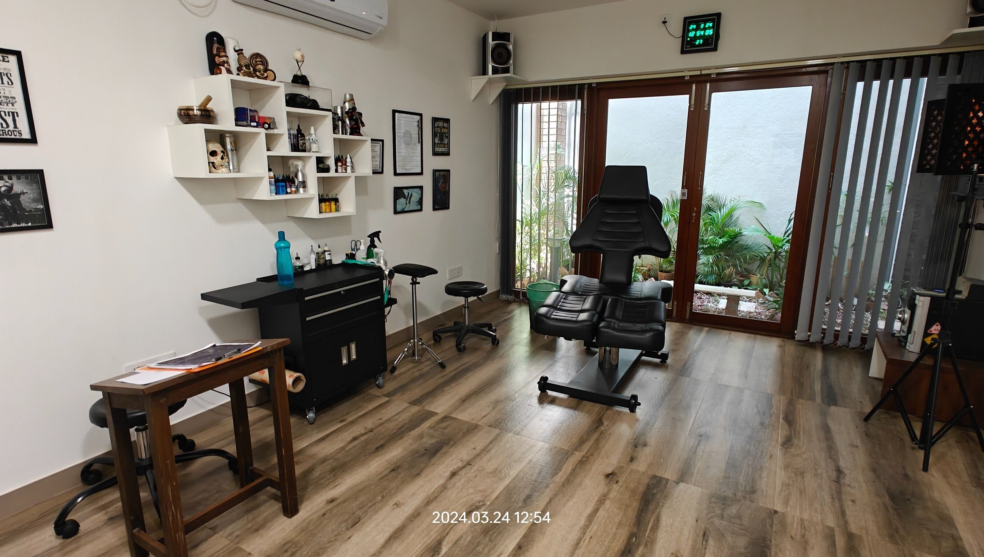 Interior of Dark Arts The Tattoo Studio in Bengaluru, Karnataka, IN, featuring stylish decor and tattoo equipment.