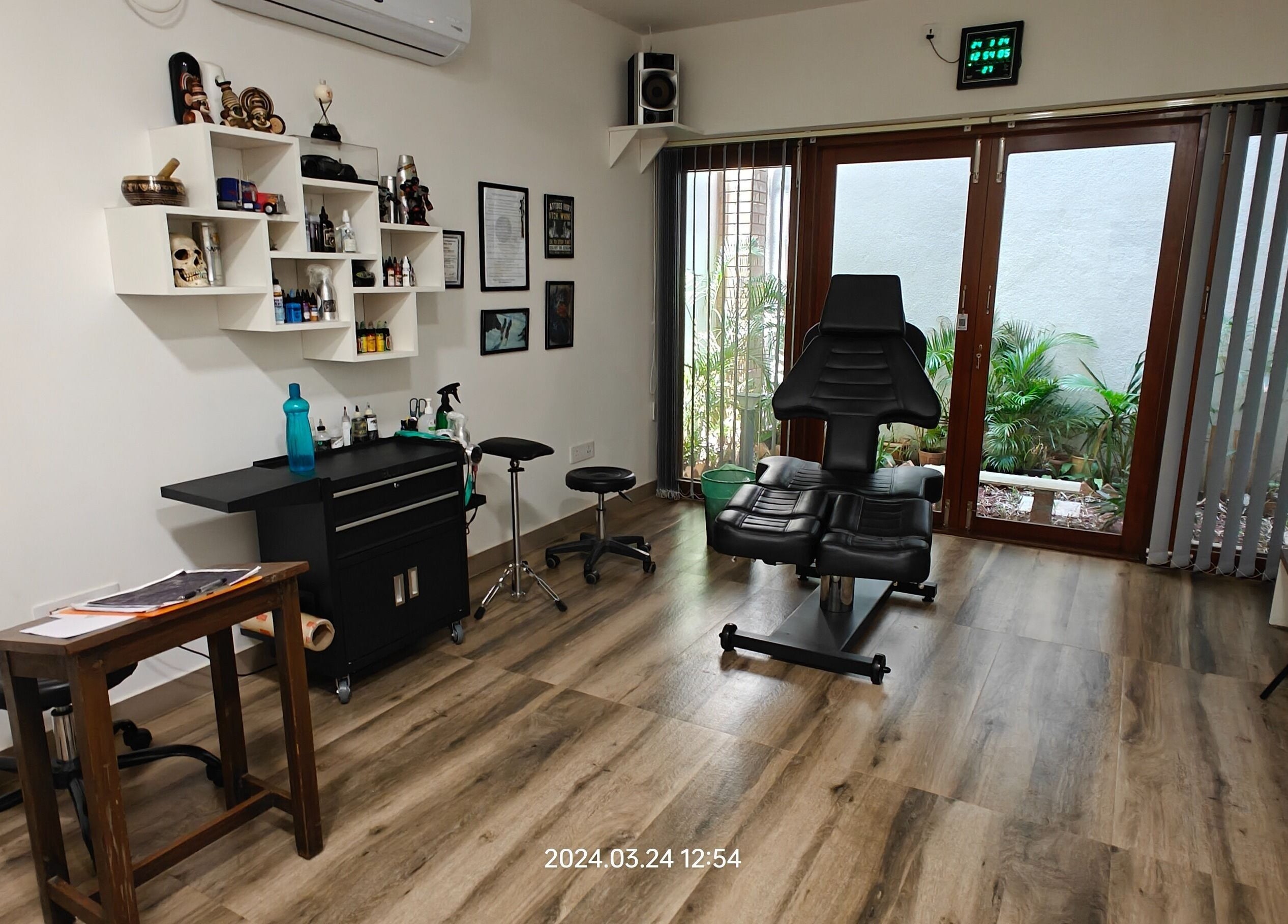 Interior of Dark Arts The Tattoo Studio in Bengaluru, Karnataka, IN, featuring stylish decor and tattoo equipment.