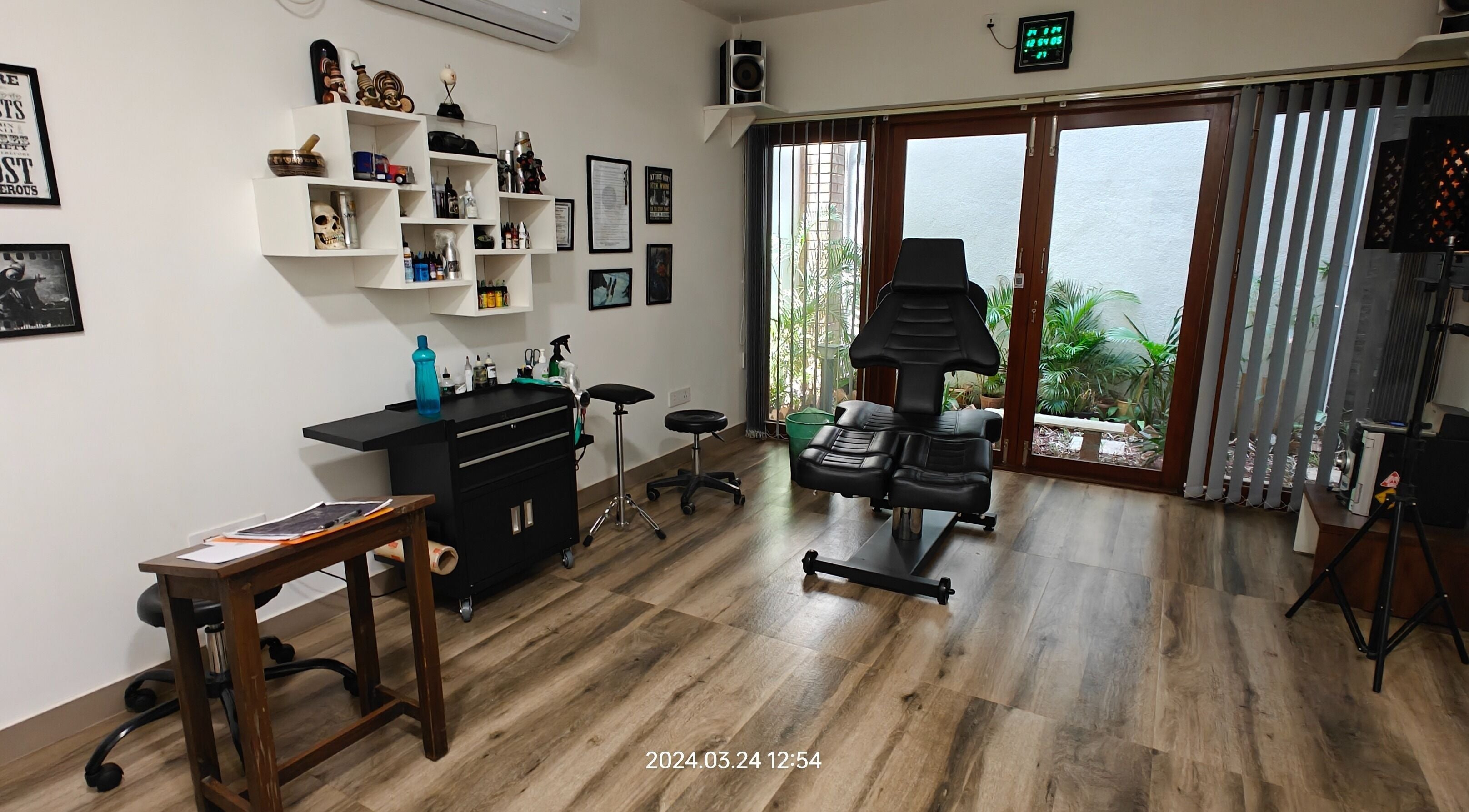 Interior of Dark Arts The Tattoo Studio in Bengaluru, Karnataka, IN, featuring stylish decor and tattoo equipment.