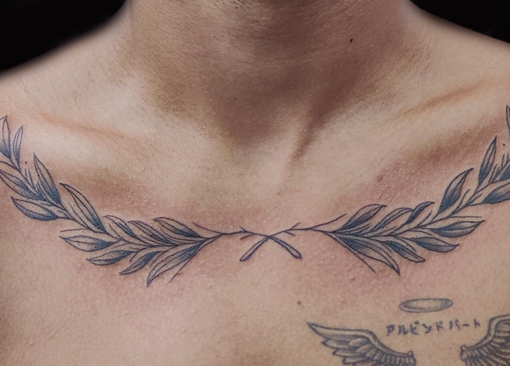 Elegant collarbone tattoo at Dark Arts The Tattoo Studio, Bengaluru, Karnataka, IN, showcasing olive branch design.