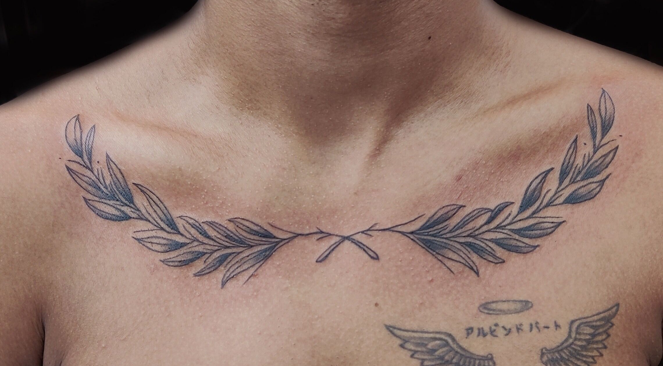 Elegant collarbone tattoo at Dark Arts The Tattoo Studio, Bengaluru, Karnataka, IN, showcasing olive branch design.