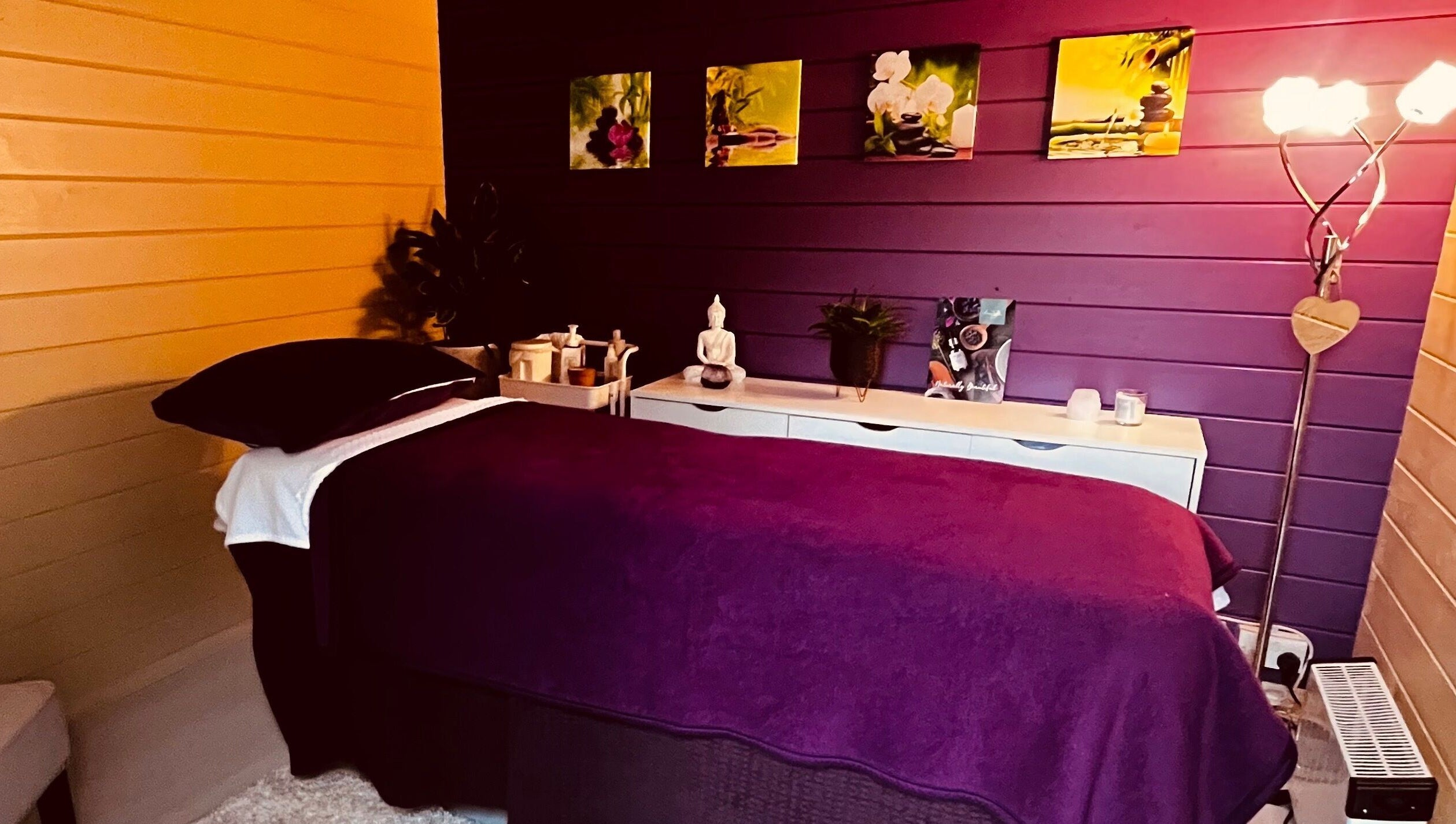 Cozy massage room at The Holistic Hideaway, Saint Neots, England, GB, with calming decor and dim lighting.