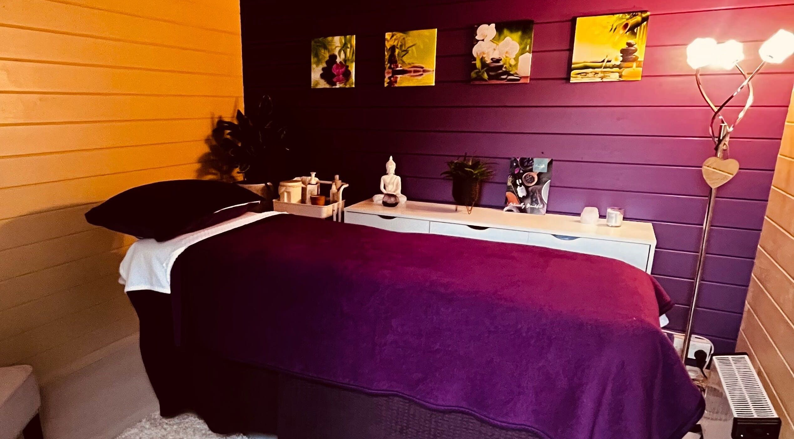 Cozy massage room at The Holistic Hideaway, Saint Neots, England, GB, with calming decor and dim lighting.