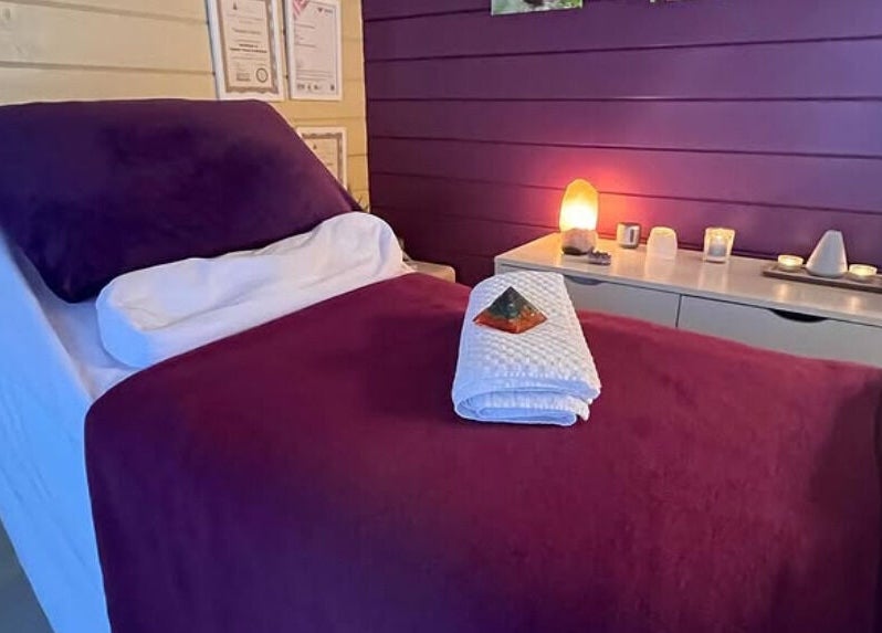 Cozy massage room at The Holistic Hideaway, Saint Neots, England, GB with soft lighting and therapeutic setup.