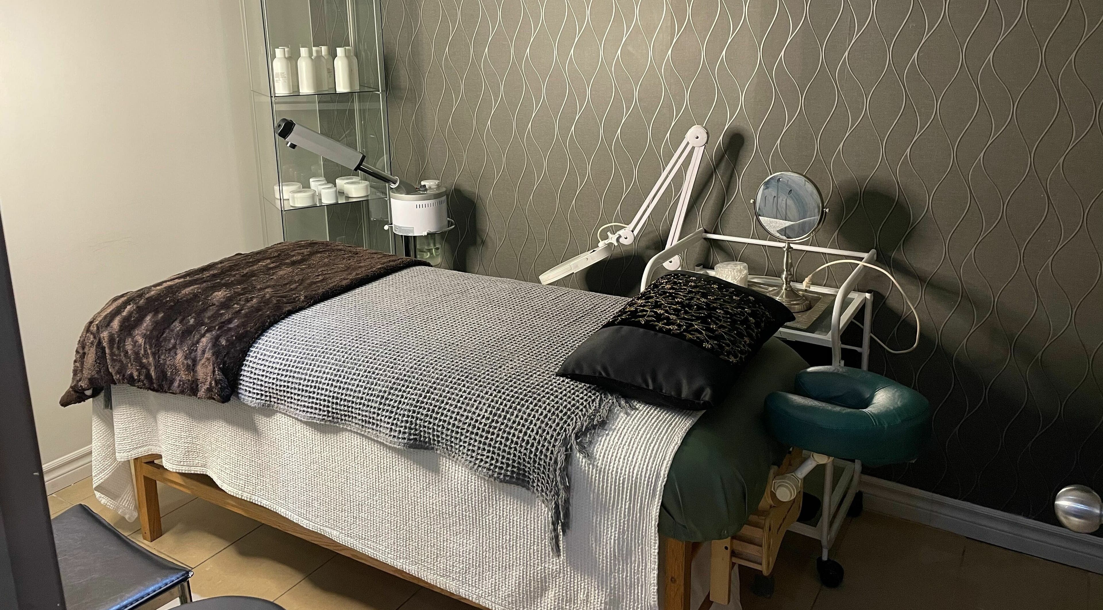 A serene treatment room at Salon Concepts Spa, Toronto, Ontario, CA, featuring a comfortable massage table.