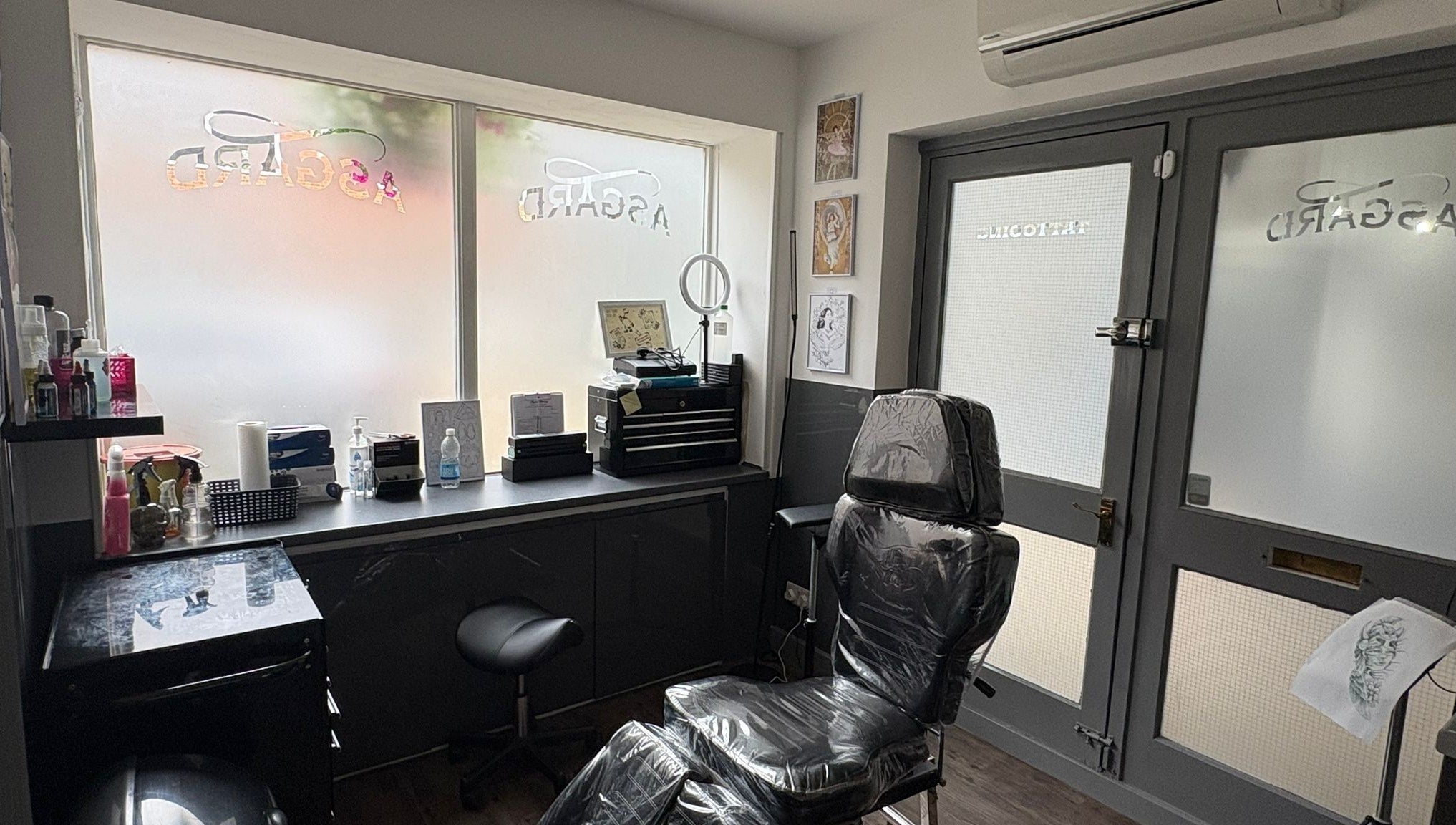 Modern interior of Asgard Body Piercing in Winchester, England, GB showcasing sleek design and piercing chair.
