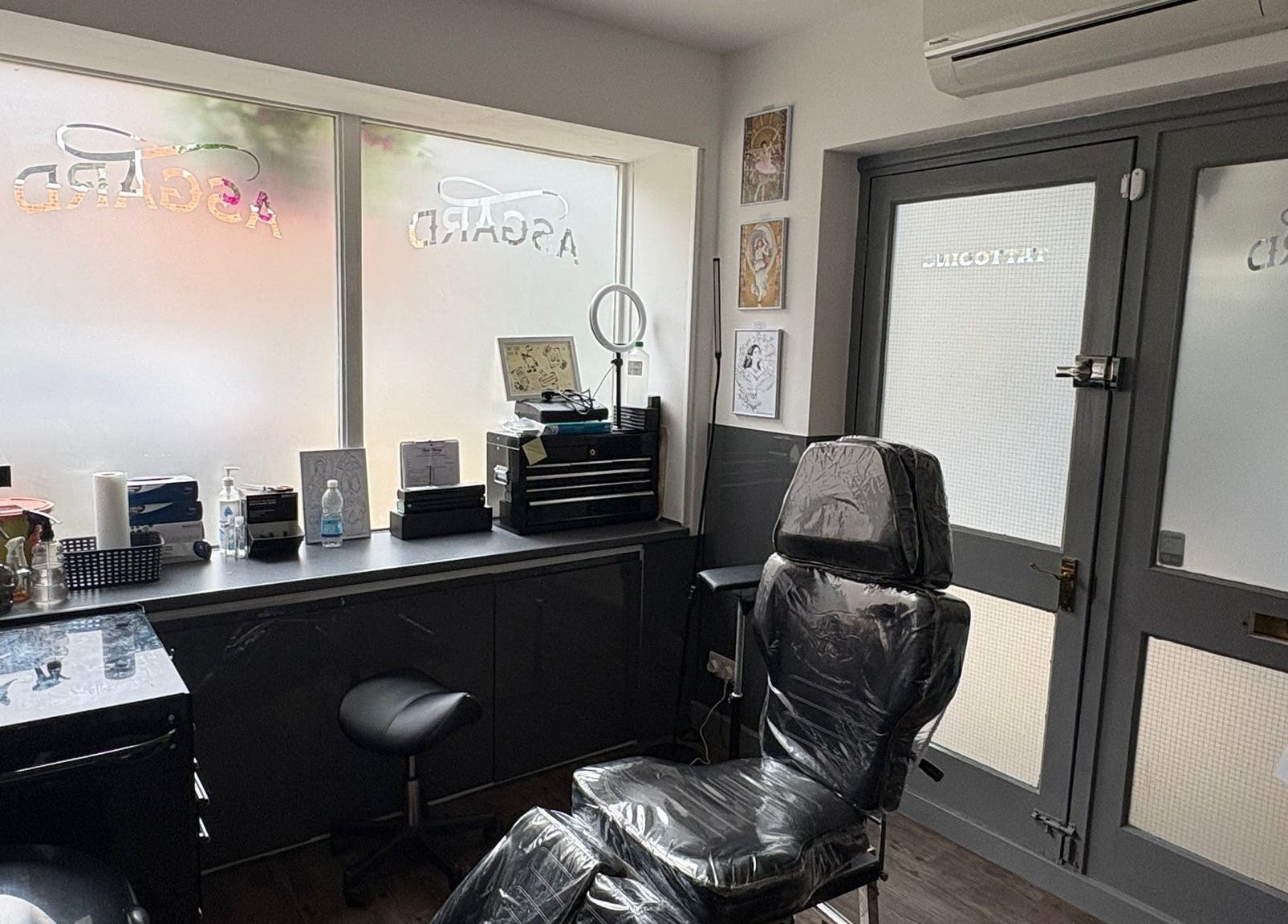 Modern interior of Asgard Body Piercing in Winchester, England, GB showcasing sleek design and piercing chair.