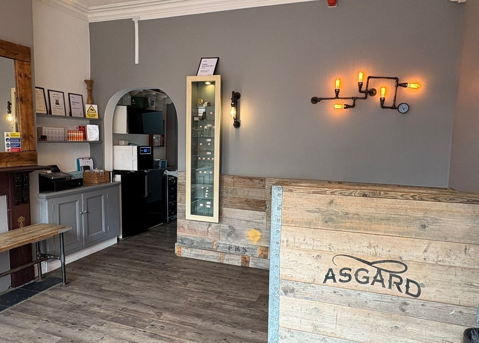 Inside of Asgard Body Piercing in Winchester, featuring a rustic wooden interior and industrial lighting.