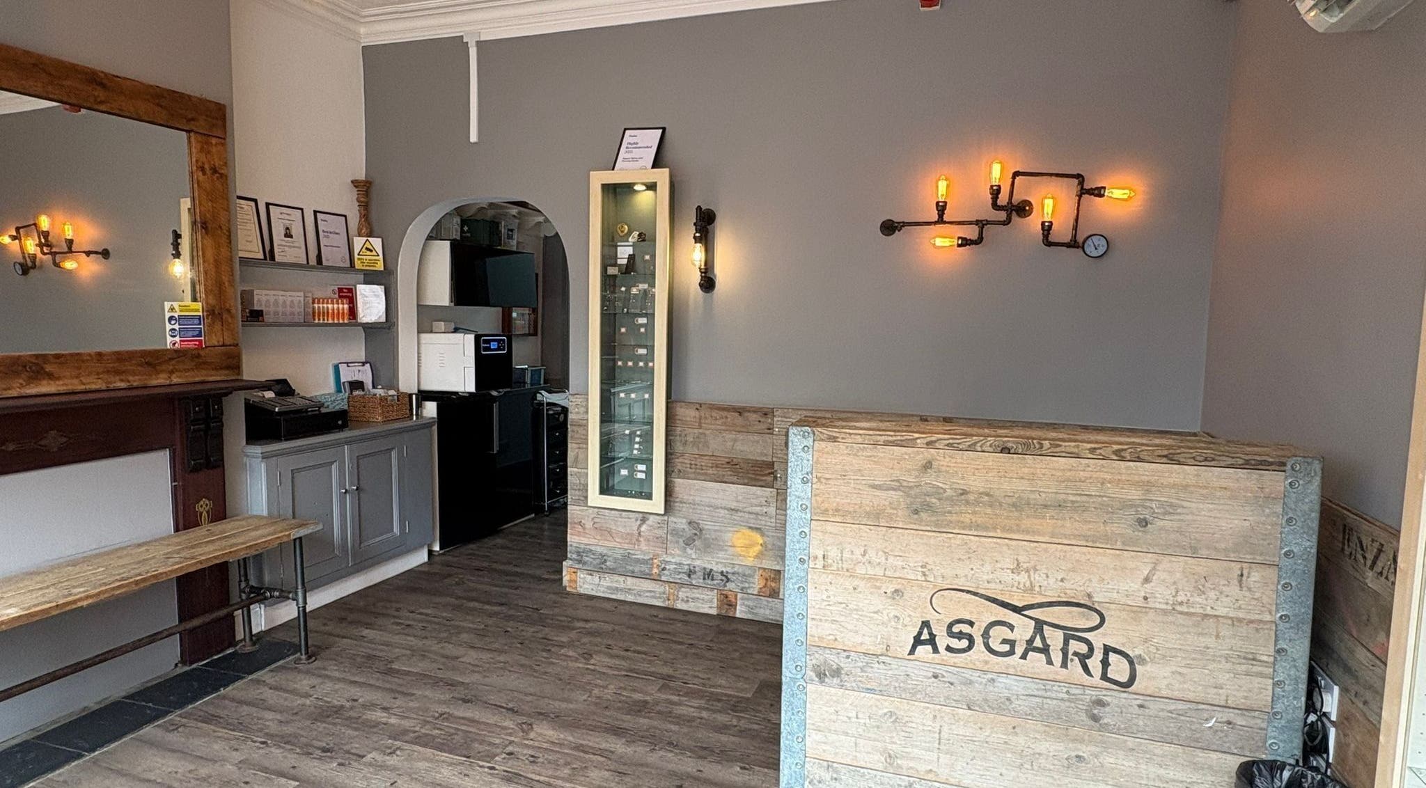 Inside of Asgard Body Piercing in Winchester, featuring a rustic wooden interior and industrial lighting.