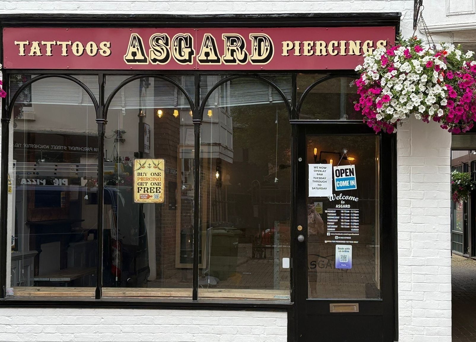 Front view of Asgard Body Piercing (Winchester) with vibrant floral decor in Winchester, England, GB.