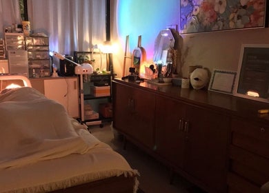 Relaxing treatment room at Nude Beauty in Daerah Khusus Ibukota Jakarta, softly lit with warm, soothing lights.