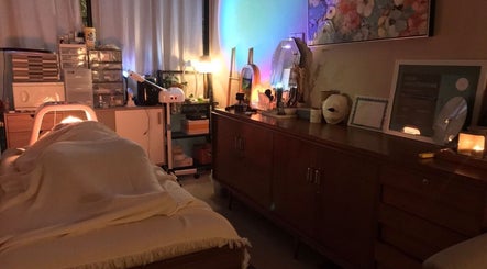 Relaxing treatment room at Nude Beauty in Daerah Khusus Ibukota Jakarta, softly lit with warm, soothing lights.