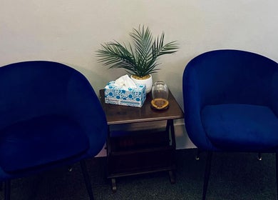 Elegant waiting area at Body Shop Studio For Men, Cape Town, ZA with blue chairs and decor.