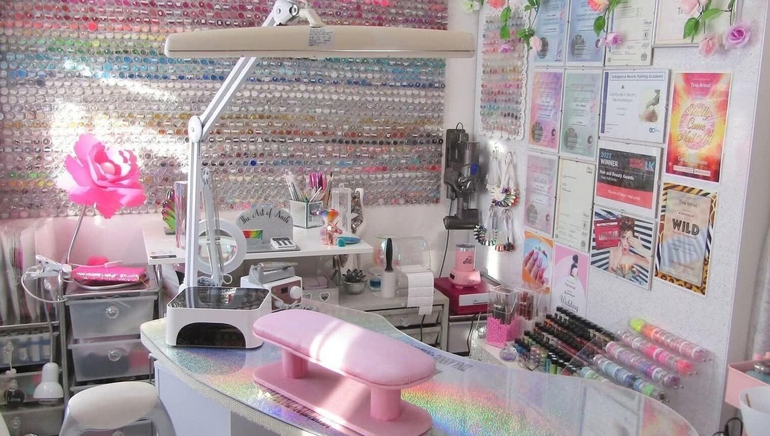 Vibrant nail studio at The Art of Nails, Trowbridge, England, GB, showcasing colorful polish and decor.