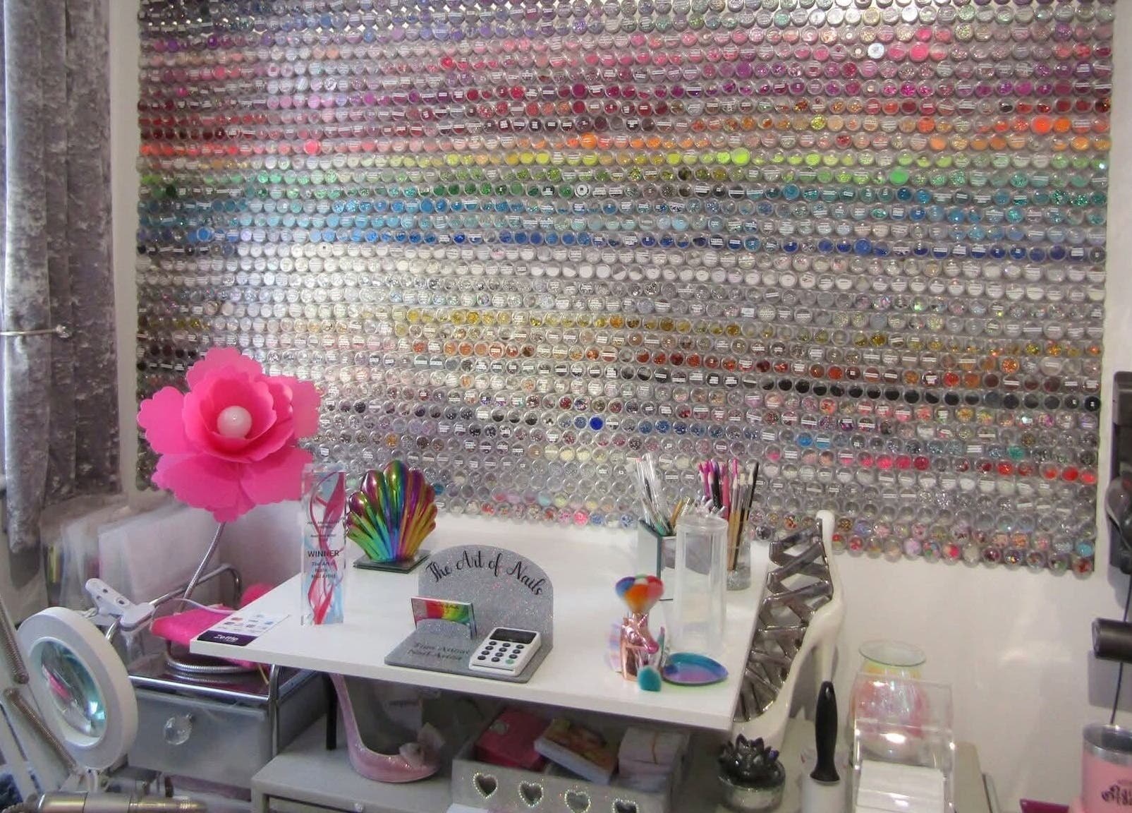 Colorful nail art display wall at The Art of Nails, Trowbridge, England, GB, showcasing vibrant creativity.