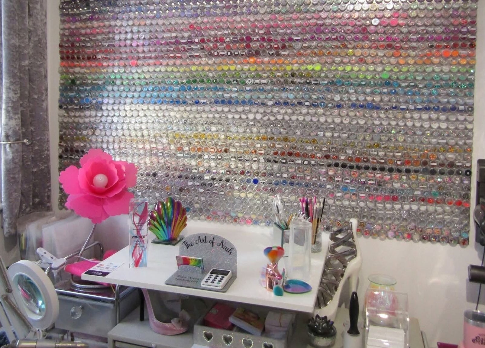 Colorful nail art display wall at The Art of Nails, Trowbridge, England, GB, showcasing vibrant creativity.