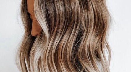 Glossy wavy blonde hair at STORI, Birmingham, England, GB. Perfectly styled for a chic look.
