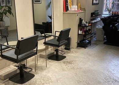 Modern salon chairs and mirrors at STORI in Birmingham, England, GB, showcasing elegant beauty ambiance.