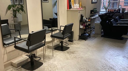 Modern salon chairs and mirrors at STORI in Birmingham, England, GB, showcasing elegant beauty ambiance.