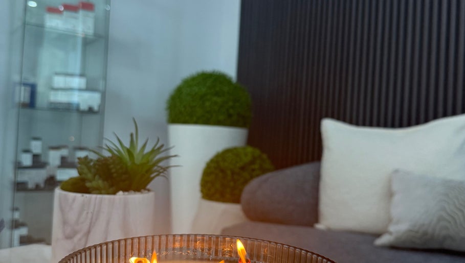 Cozy lounge area with candle at Bliss Spa & Wellness, San Juan, San Juan, PR offering relaxing ambiance.