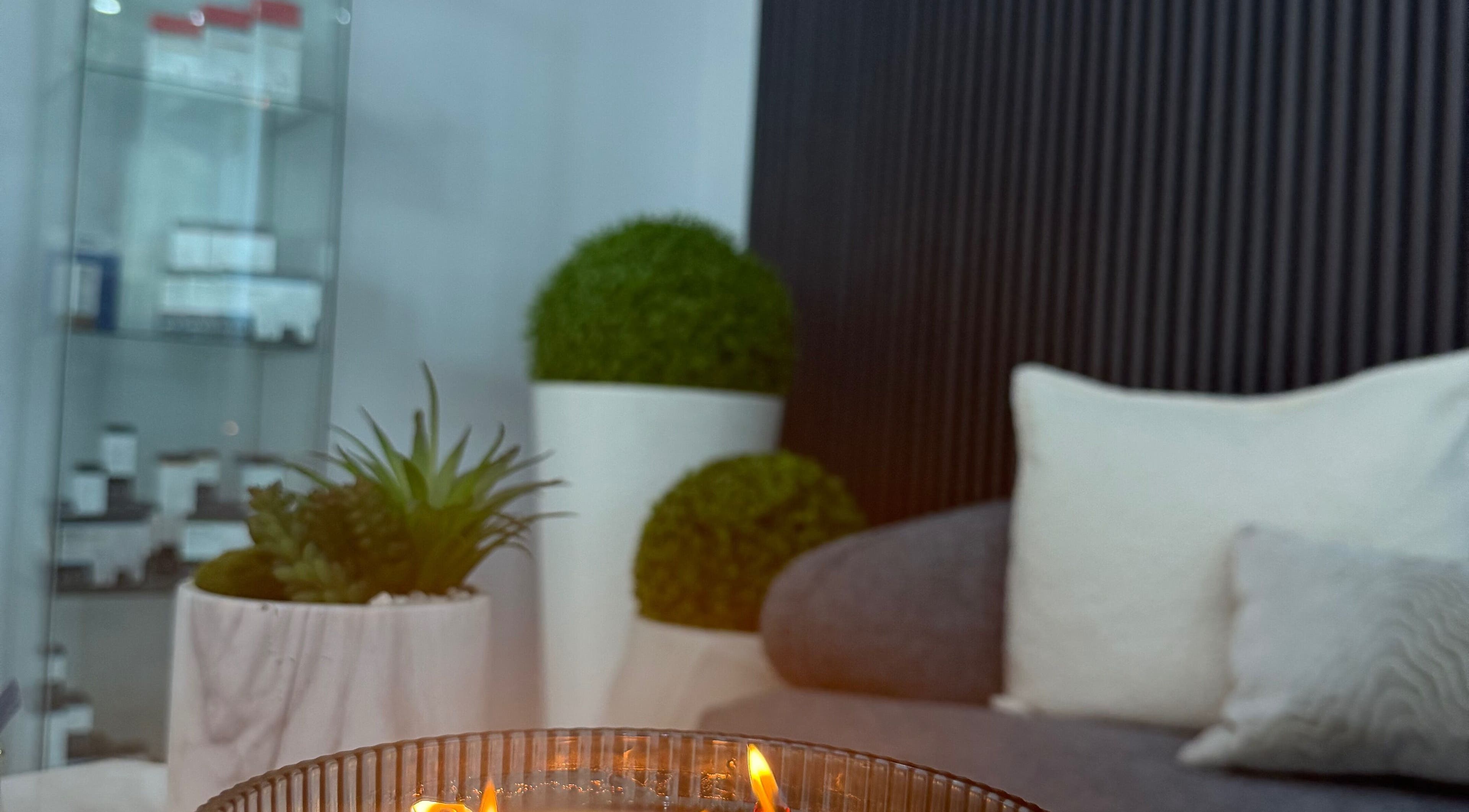 Cozy lounge area with candle at Bliss Spa & Wellness, San Juan, San Juan, PR offering relaxing ambiance.