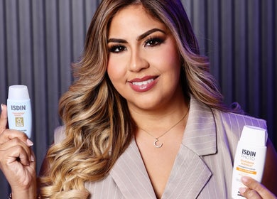 Smiling woman holding skincare products at Bliss Spa & Wellness, San Juan, San Juan, PR.