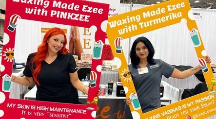 Two women hold colorful frames at Waxed by Jan in El Paso, Texas, US, showcasing vibrant waxing services.