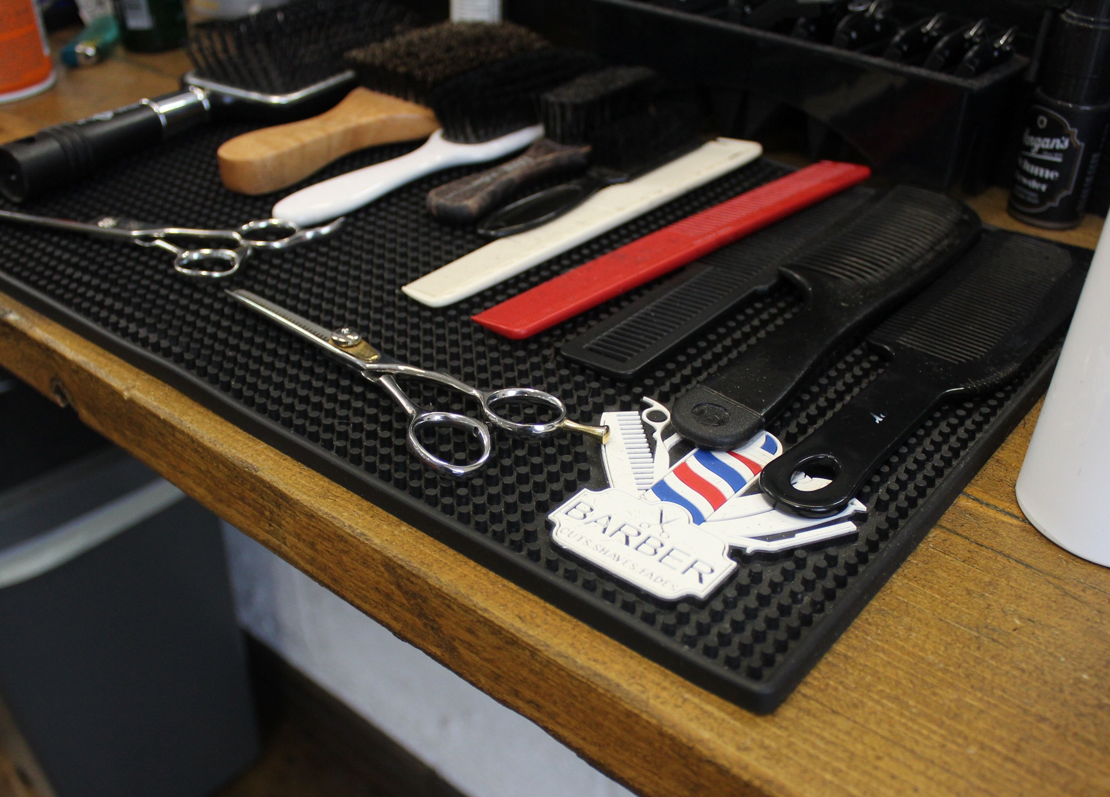 Styling tools at Lewis' Barbershop in Cambridge, England, GB, highlight expert grooming services.
