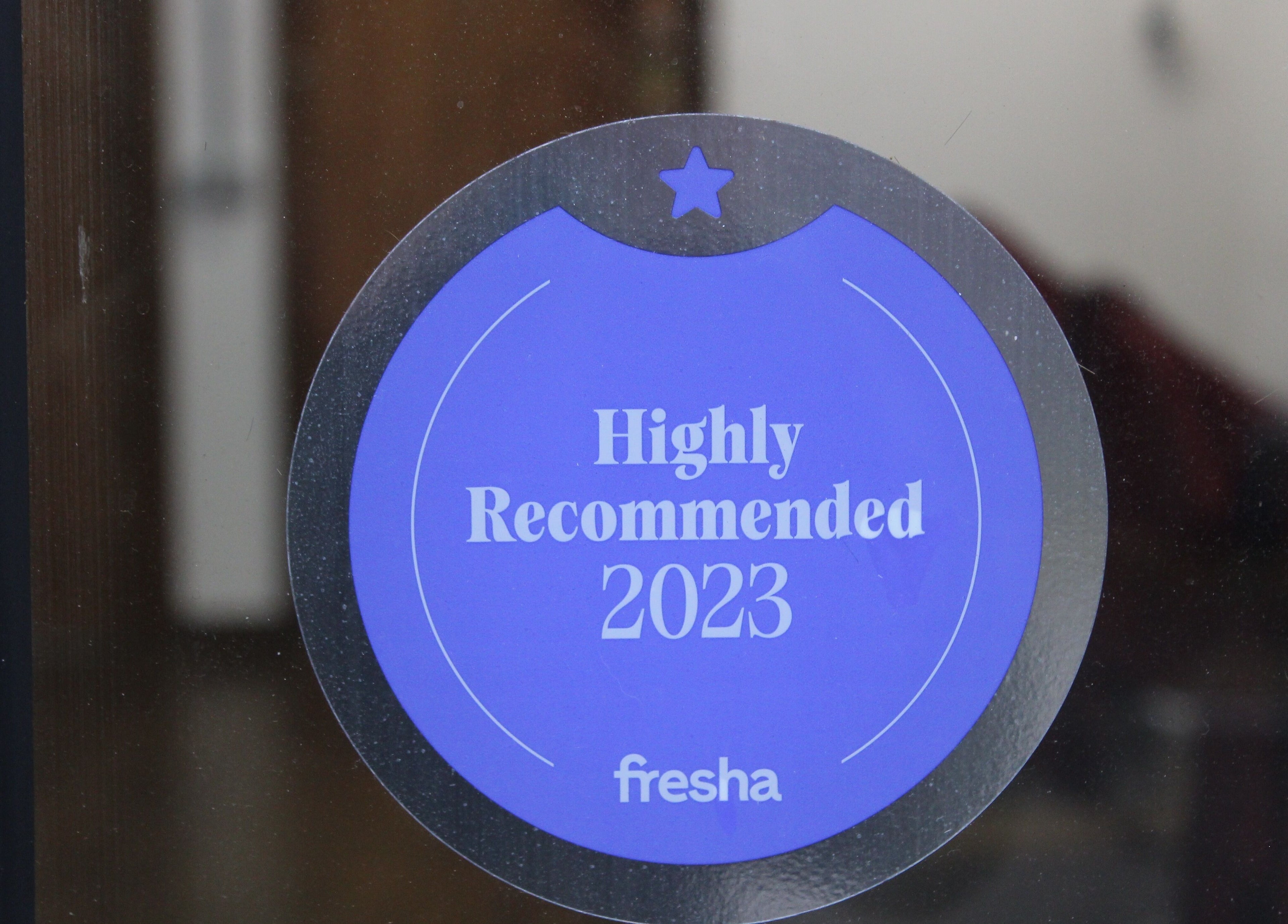 Highly Recommended 2023 sticker at Lewis' Barbershop, Cambridge, England, GB on display door.