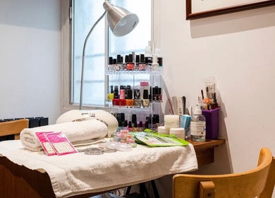Cozy nail care station at Reborn Clinic, London, England, GB featuring tools and vibrant polishes.