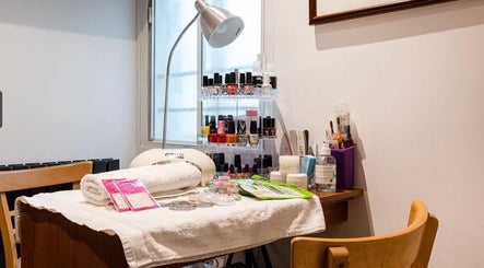 Cozy nail care station at Reborn Clinic, London, England, GB featuring tools and vibrant polishes.