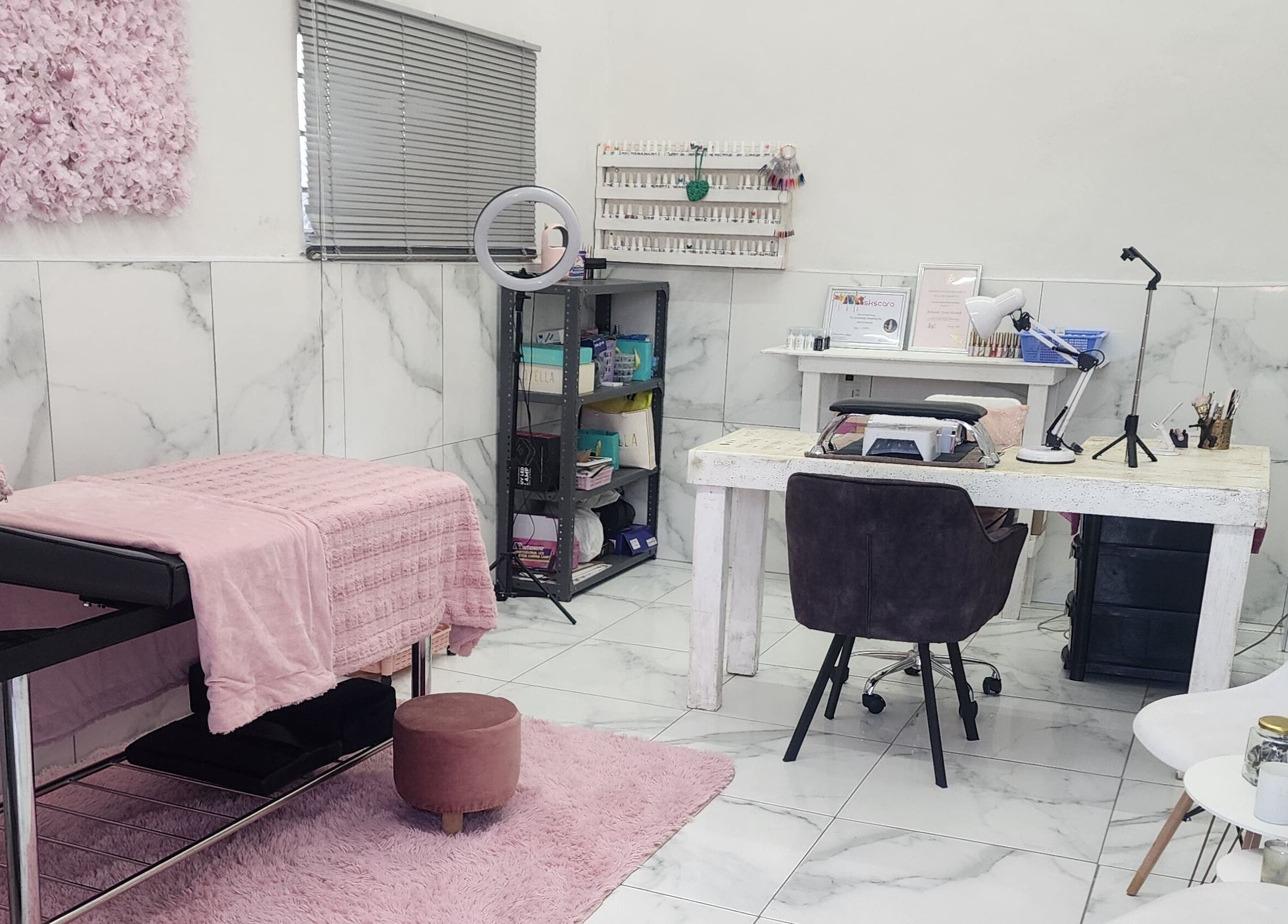 Chic interior of Sparkled By Crystal in Gqeberha, Eastern Cape, ZA, featuring a pink-accented treatment area.
