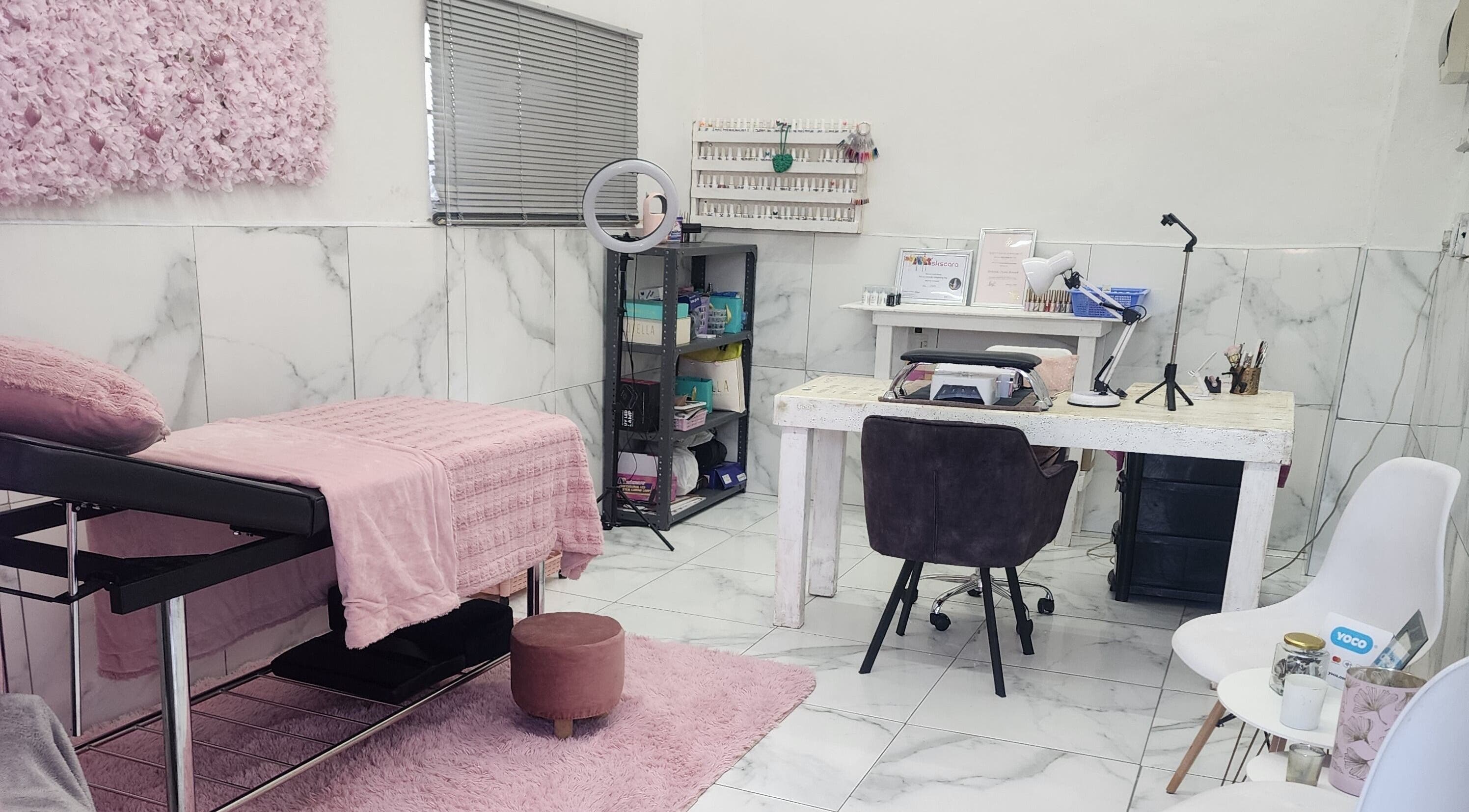 Chic interior of Sparkled By Crystal in Gqeberha, Eastern Cape, ZA, featuring a pink-accented treatment area.