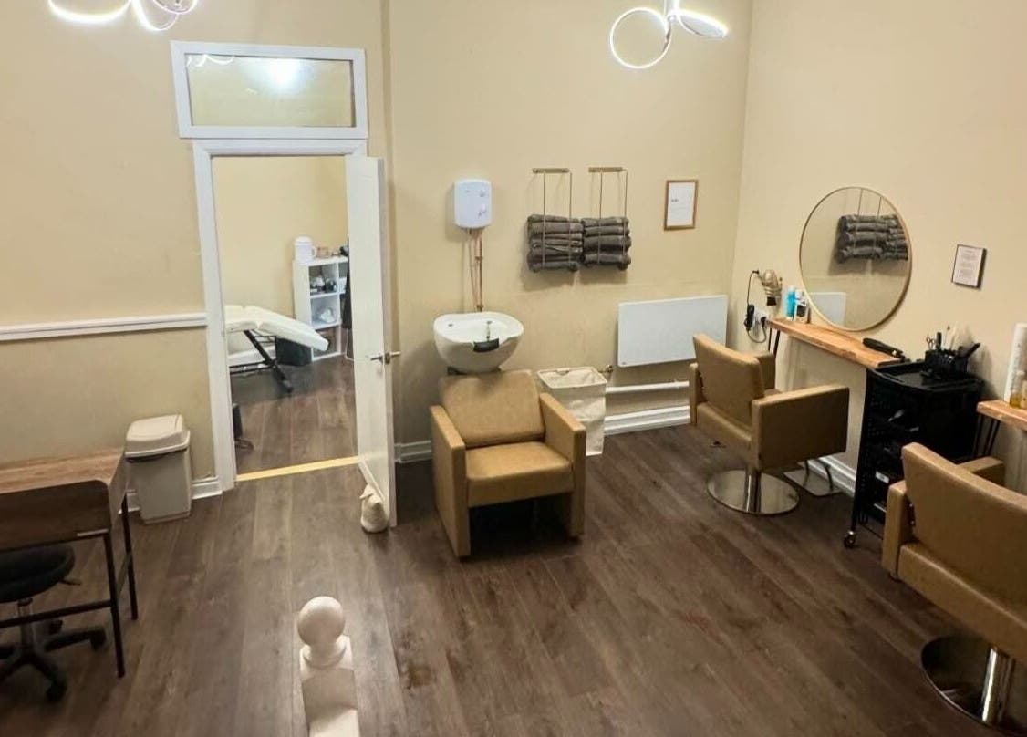 Elegant salon interior at Look and Lash, Alnwick, England, GB with modern chairs and mirrors.