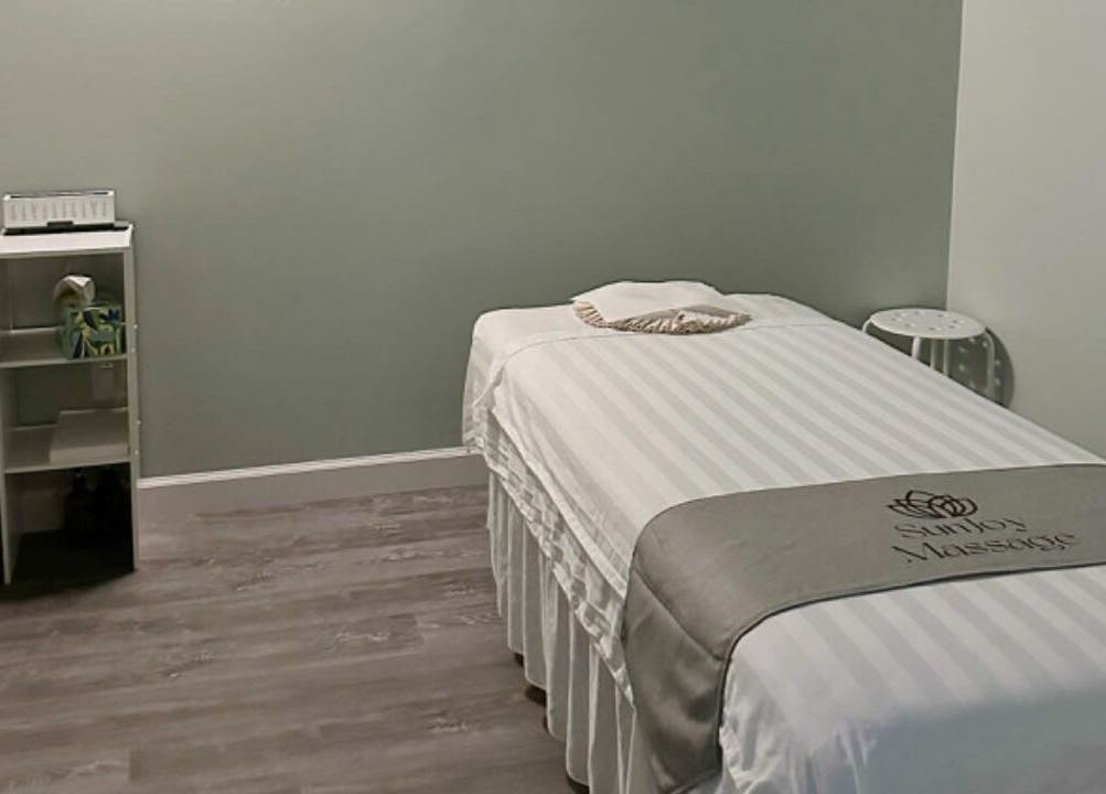 Relaxing massage room at Sun Joy Massage Spa, Wichita, Kansas, US, with massage bed and soothing decor.