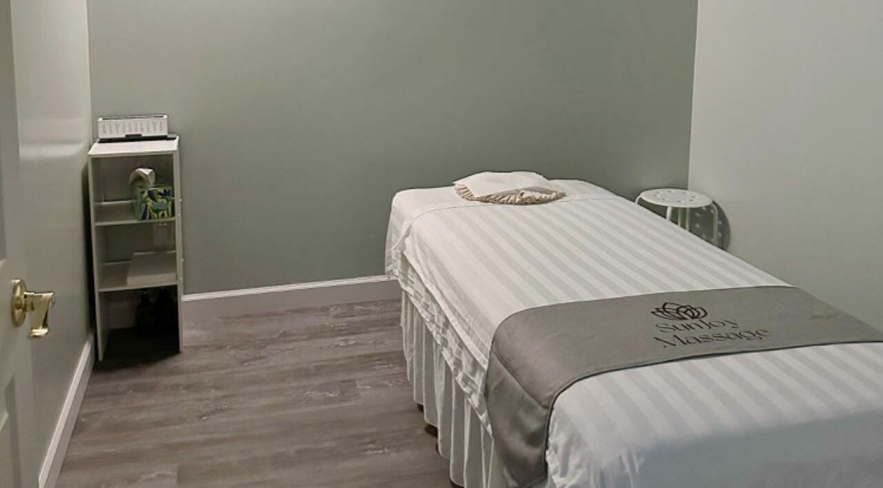 Relaxing massage room at Sun Joy Massage Spa, Wichita, Kansas, US, with massage bed and soothing decor.