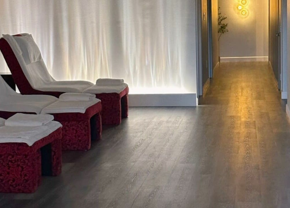 Relaxing massage chairs at Sun Joy Massage Spa, Wichita, Kansas, US, in a serene, softly-lit corridor.