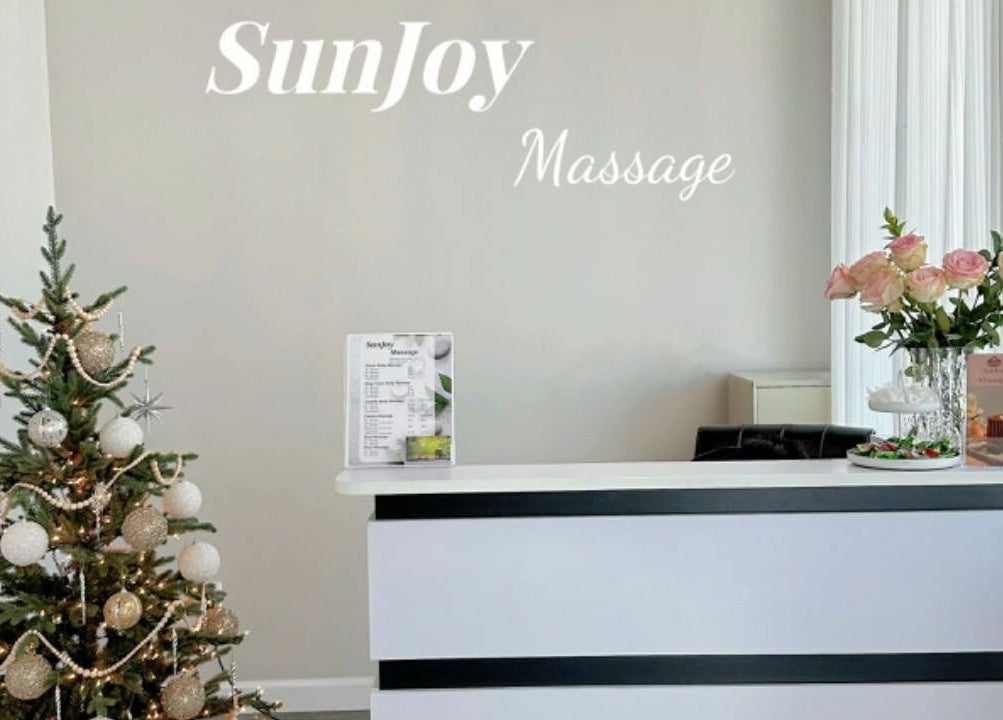 Reception area at Sun Joy Massage Spa in Wichita, Kansas, US with festive decor and flowers.