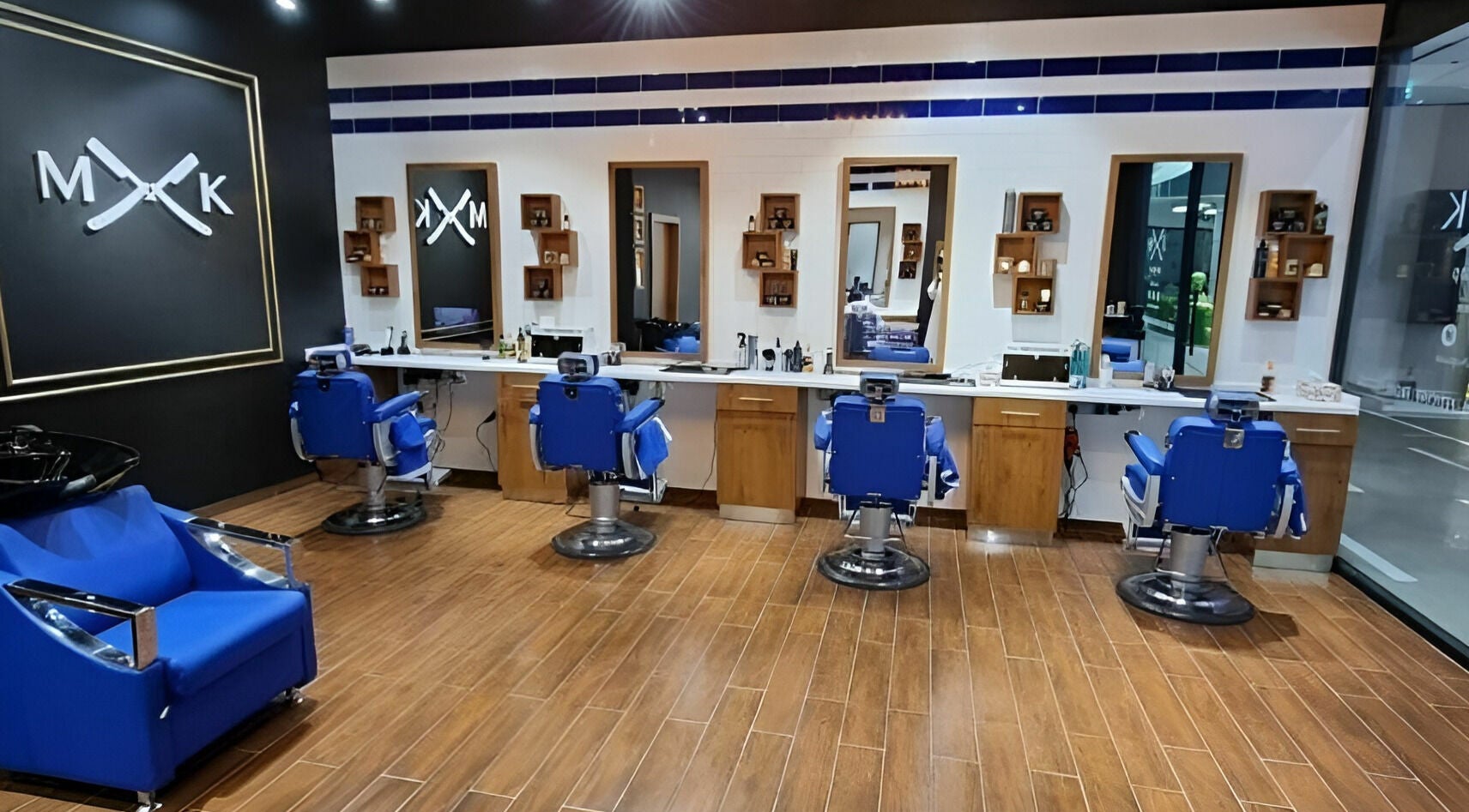 Elegant interior of MK Barbershop - Meyan Mall, featuring blue chairs and mirrors in Dubai, AE.