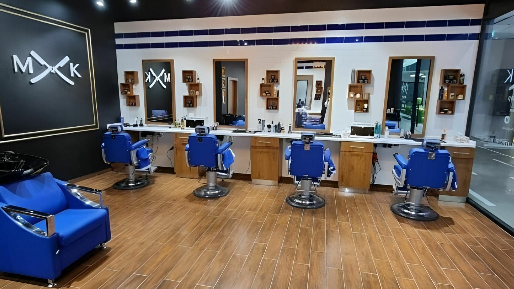 Elegant interior of MK Barbershop - Meyan Mall, featuring blue chairs and mirrors in Dubai, AE.