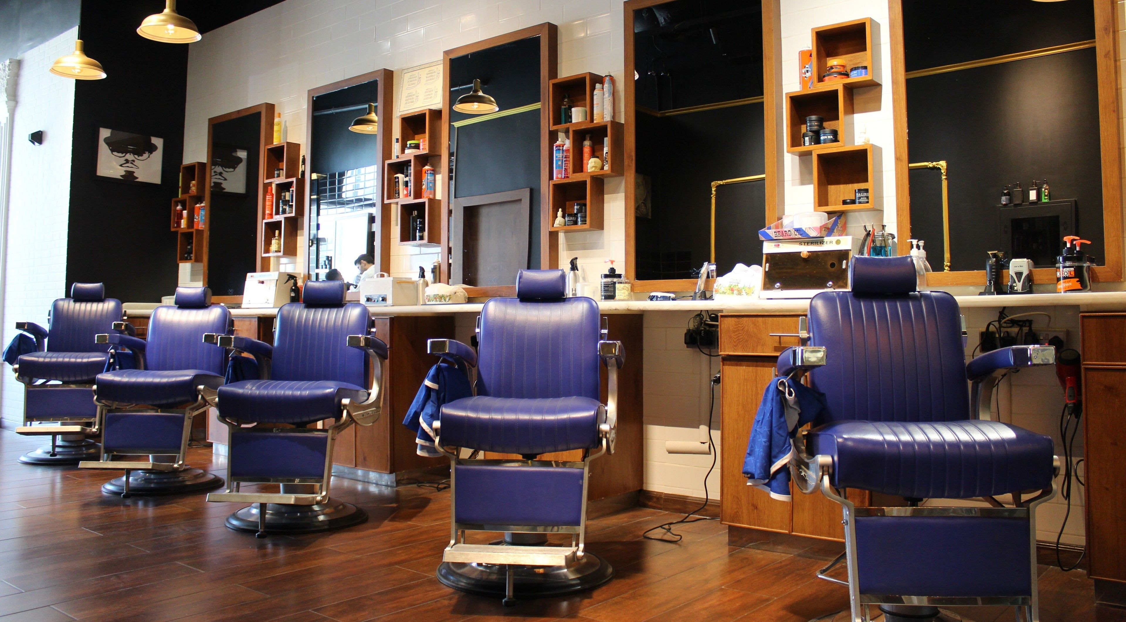 Stylish barber chairs at MK Barbershop Dar Al - Wasl Mall, Dubai, AE, create a modern grooming atmosphere.