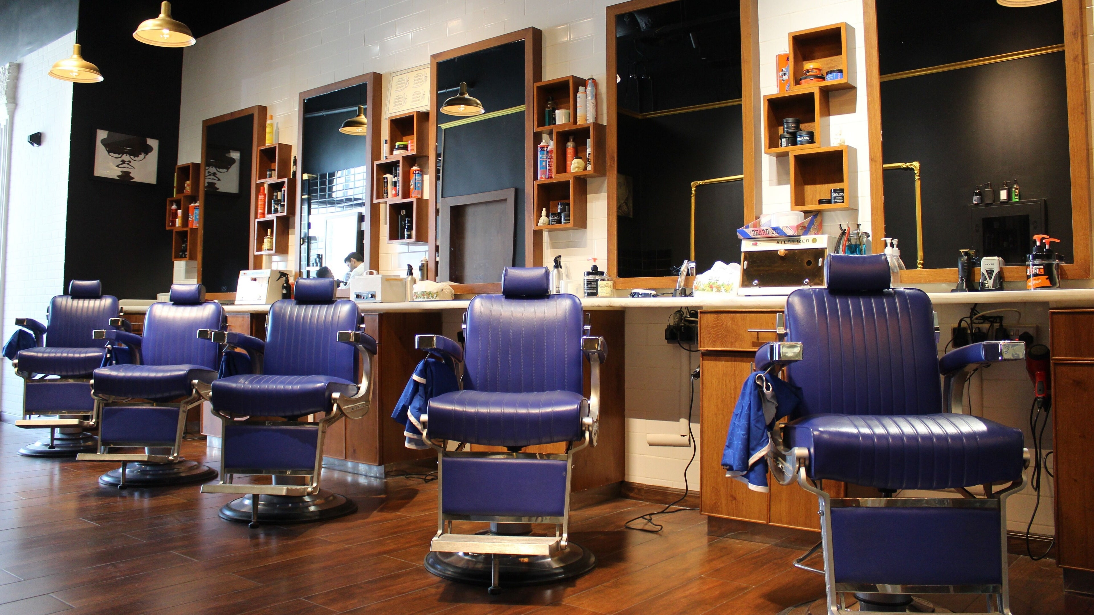 Stylish barber chairs at MK Barbershop Dar Al - Wasl Mall, Dubai, AE, create a modern grooming atmosphere.