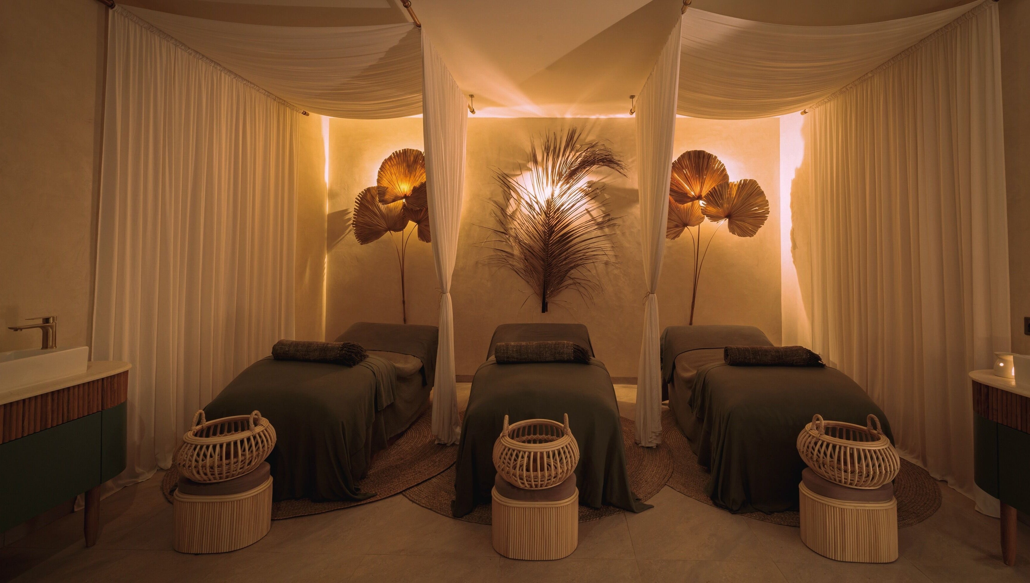 Peaceful treatment room with three beds at You Spa Umalas, Bali, Bali, ID adorned with elegant decor.