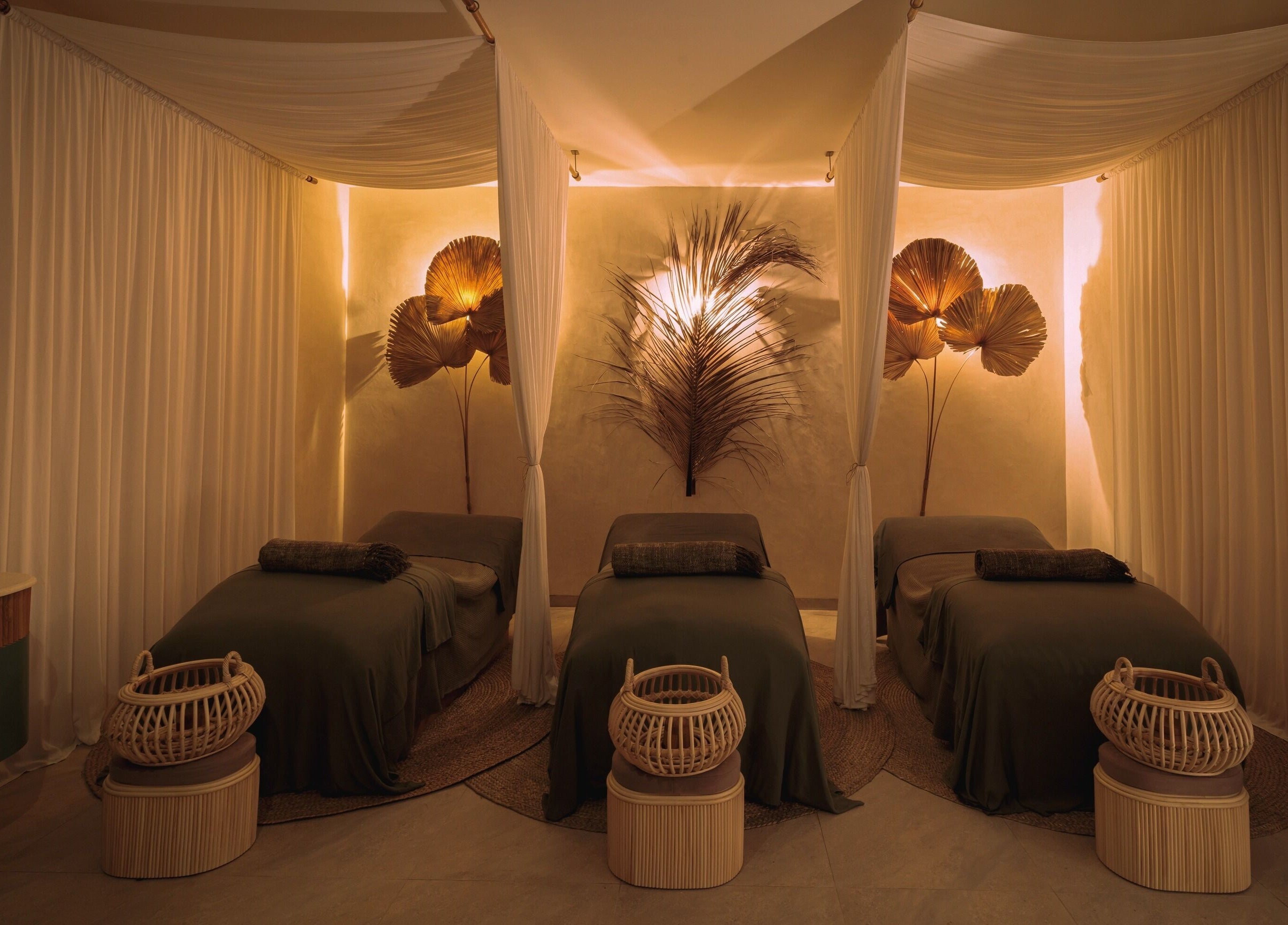 Peaceful treatment room with three beds at You Spa Umalas, Bali, Bali, ID adorned with elegant decor.