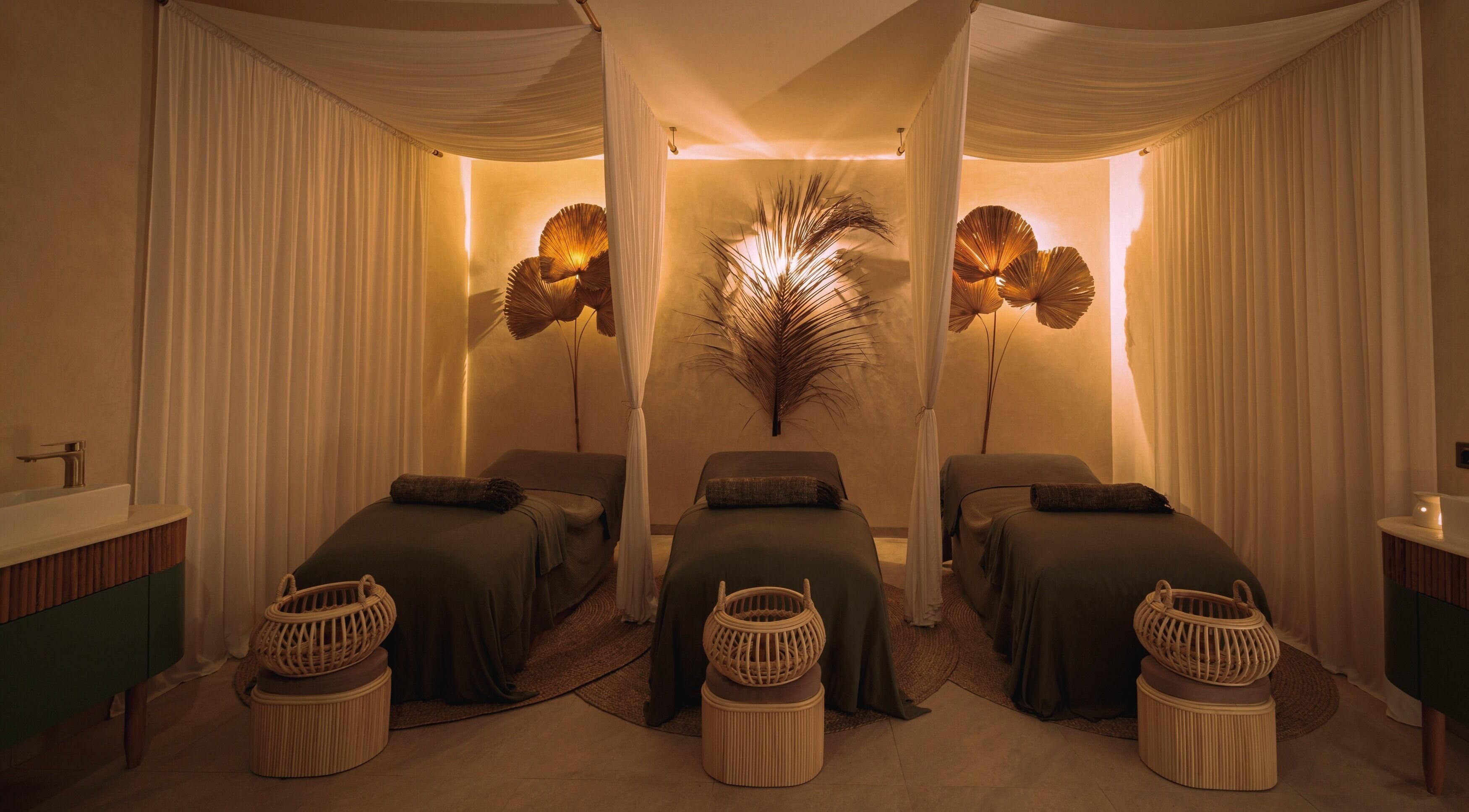 Peaceful treatment room with three beds at You Spa Umalas, Bali, Bali, ID adorned with elegant decor.