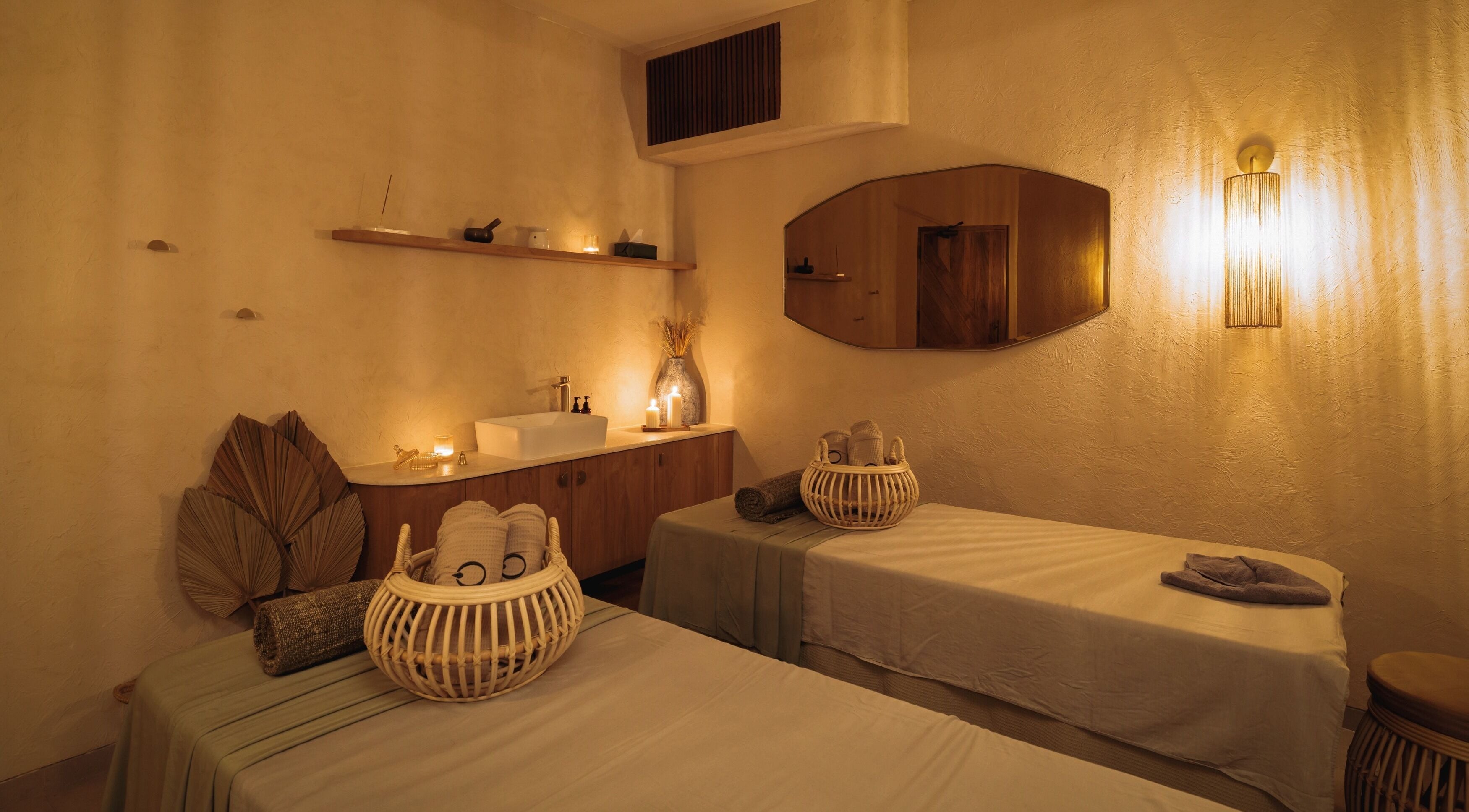 Relaxing massage room at You Spa Umalas in Bali, Bali, ID featuring warm lighting and cozy decor.